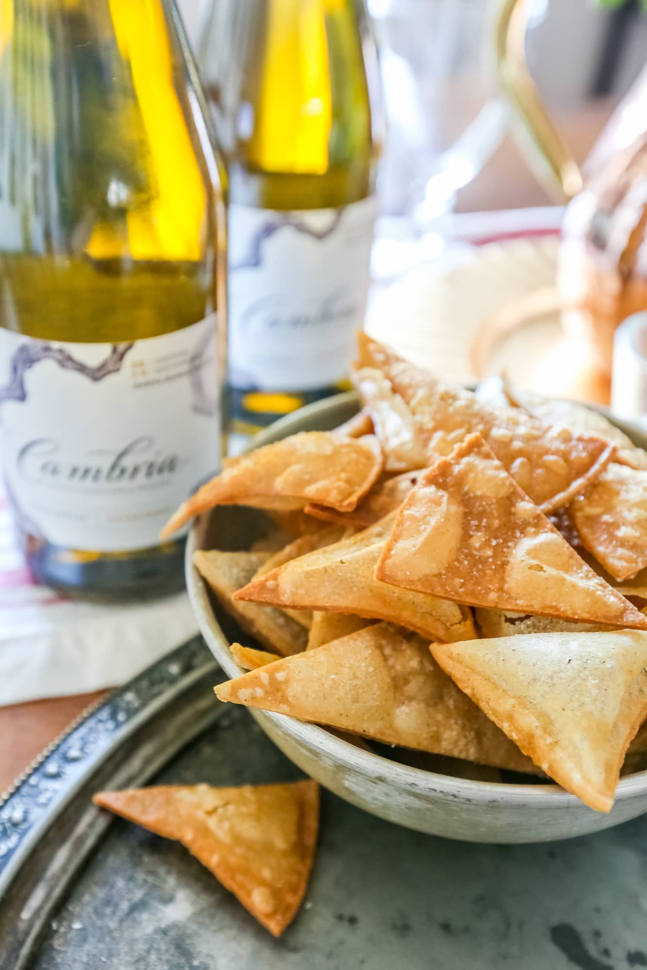 homemade tortilla chips up close with cambria wine in the background. 