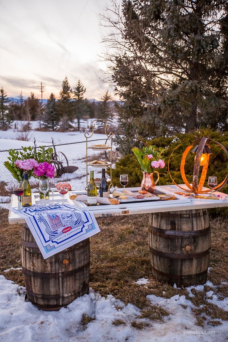 This is such a cute idea for a dinner party- a wine barrel table with an old door!