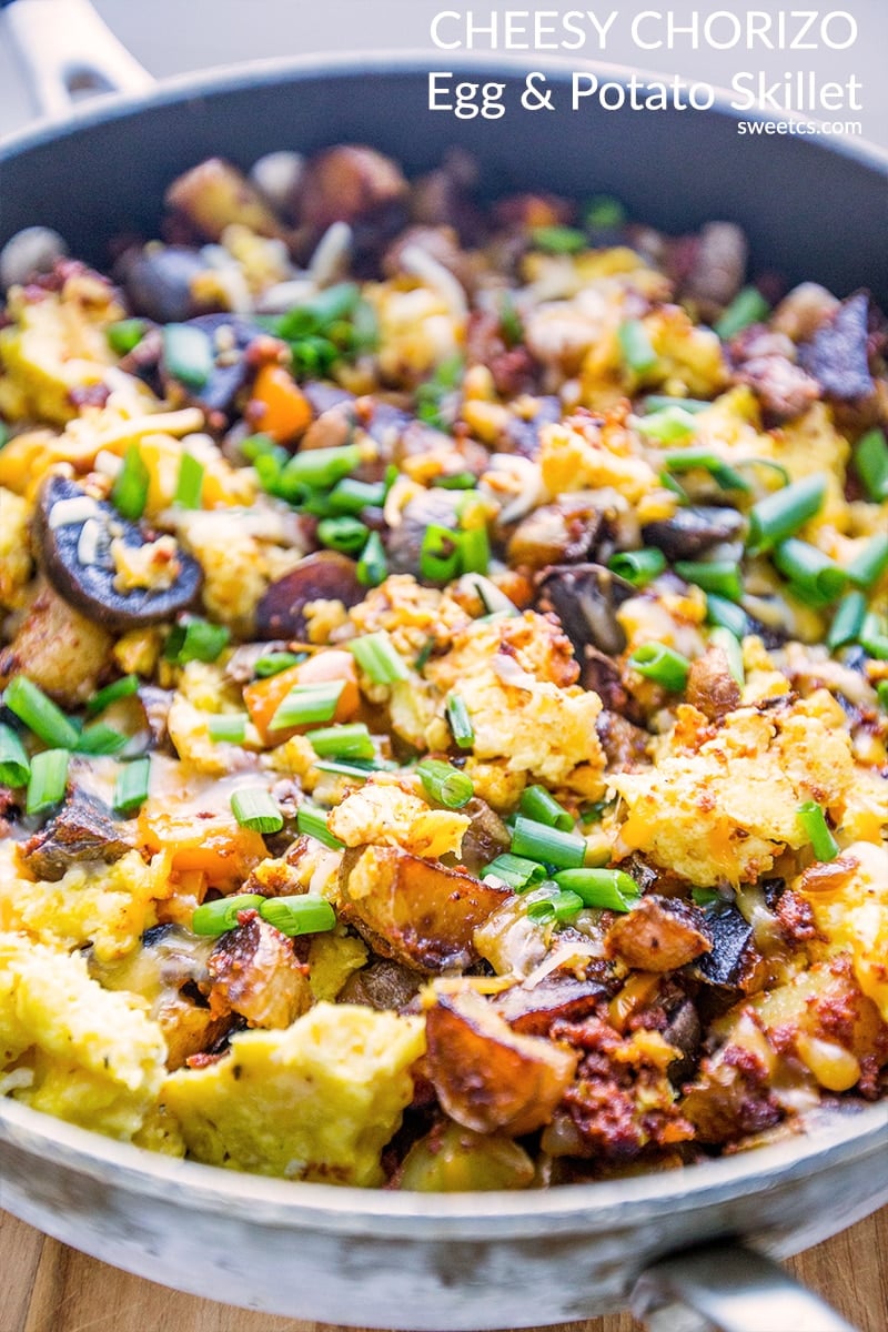 eggs, potatoes, cheese, and green onions in a skillet