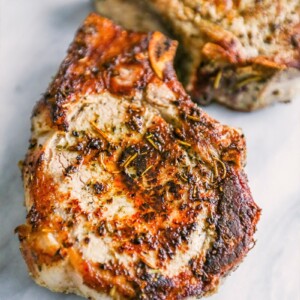 Perfect Herbs de Provence Pork Chops on a marble countertop.