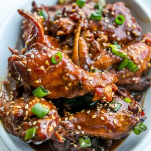 Sweet and sour honey soy chicken wings in a white bowl.