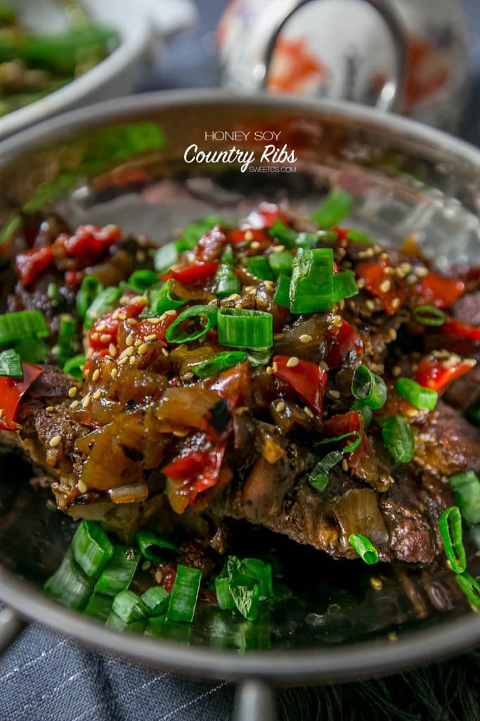 asian ribs with sesame seeds and green onions and vegetables.