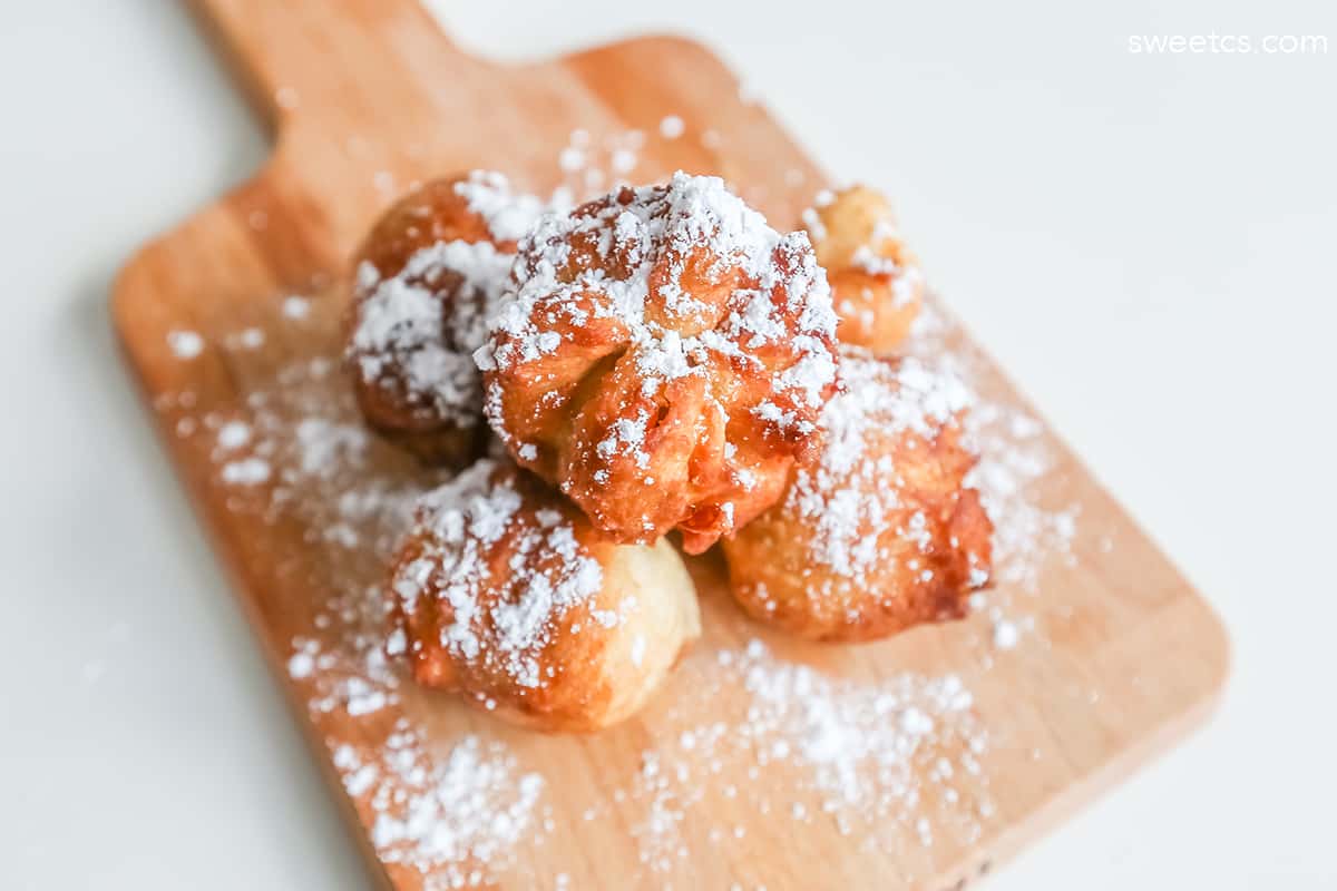 fried dough with powdered sugar on them