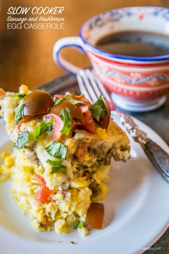 hashbrown egg casserole on a plate with tomatoes and basil on the top. 