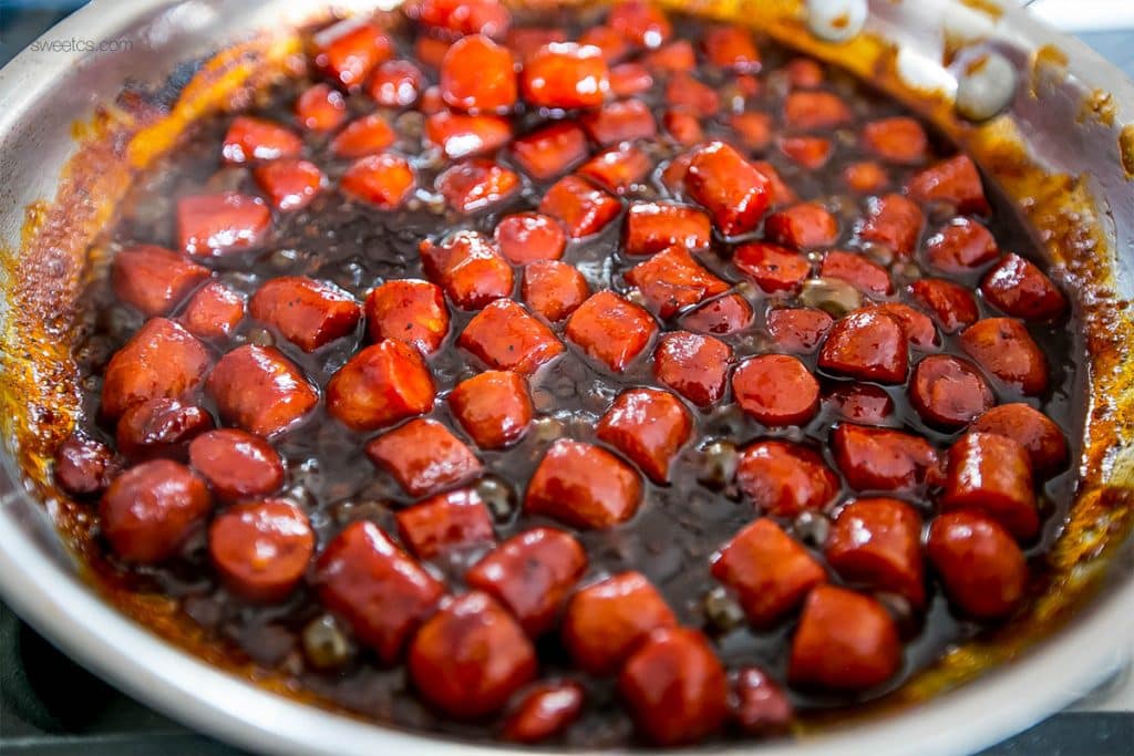 little smokies sausages in bbq sauce in a pan