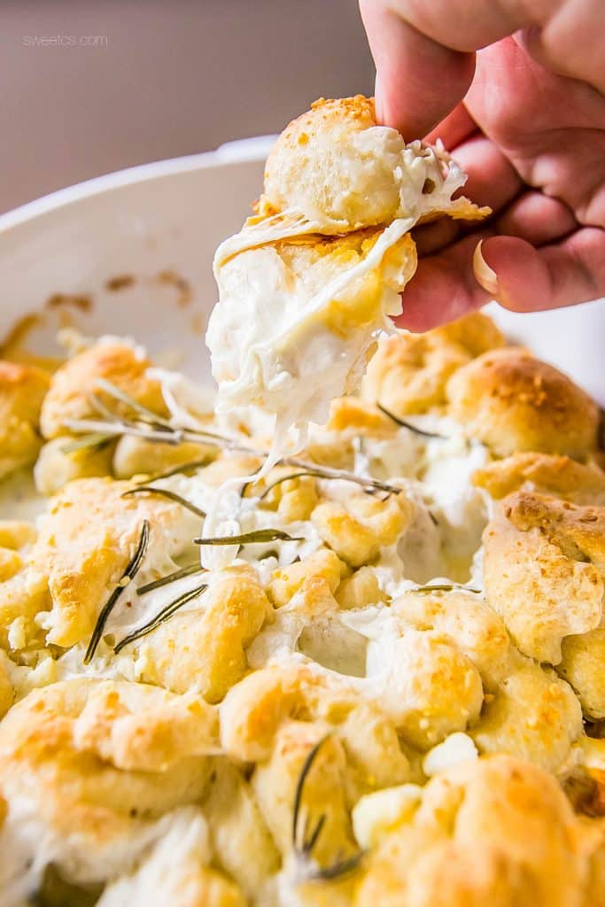 bread in a casserole dish with cheese and rosemary