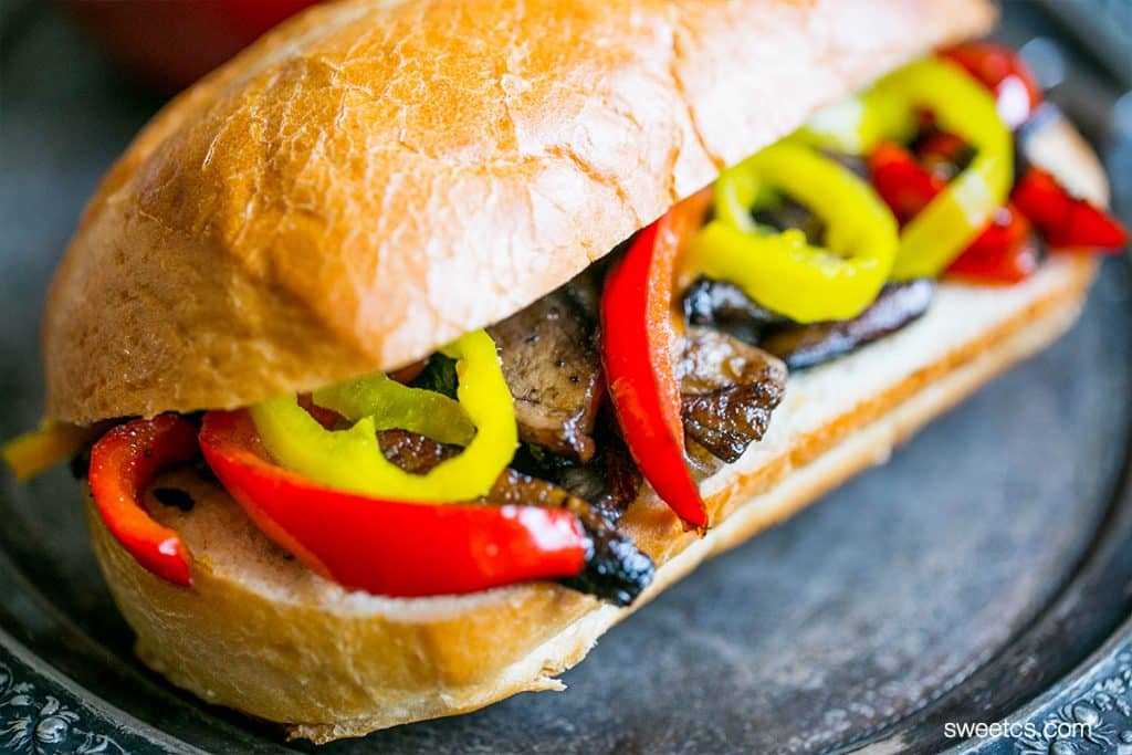 hoagie bun with steak and roasted bell peppers, mushrooms, and onions