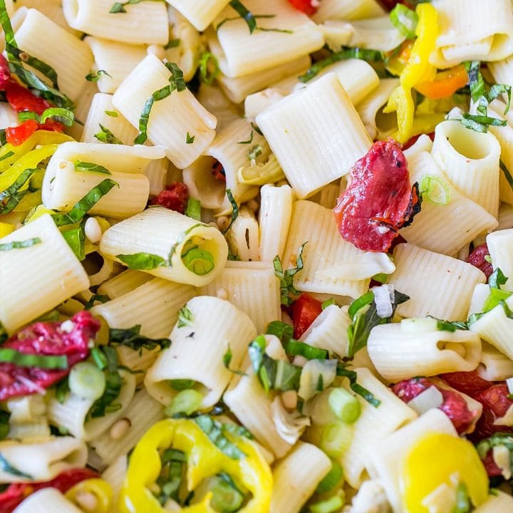 A close up of vegan pasta salad with peppers and anti-pasti.