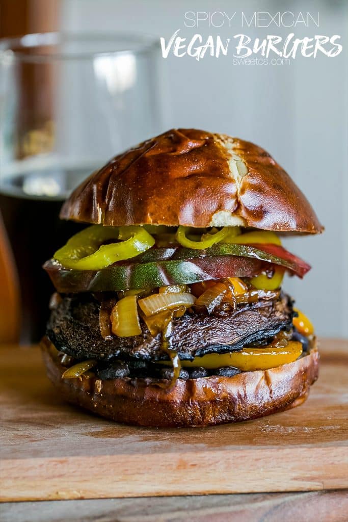 mushroom burger with tomato, banana peppers, onions, bell peppers, on a pretzel bun