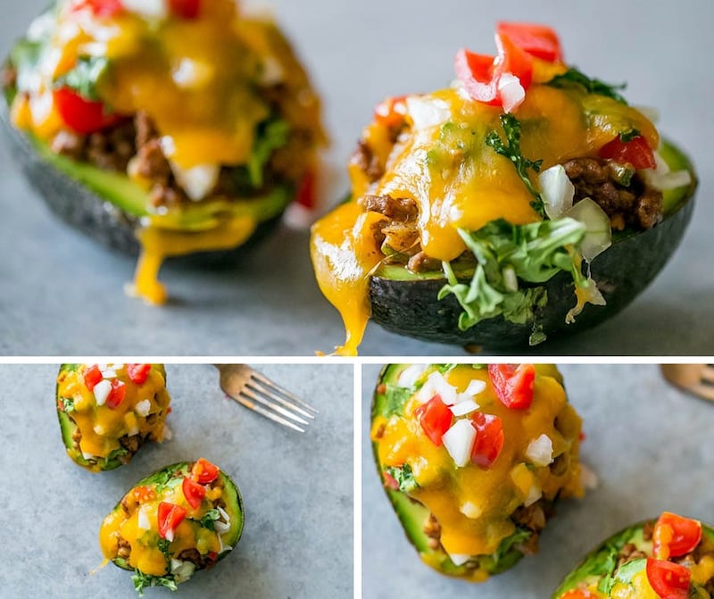 avocado half with ground beef, cheese, onion and tomato on it
