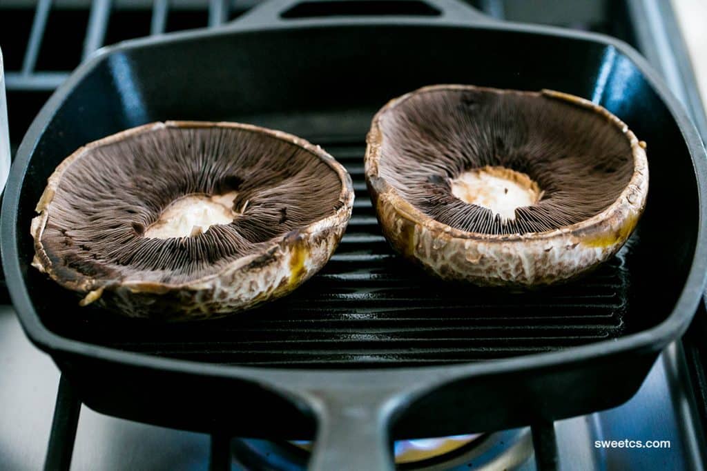 2 big portabella mushrooms in a cast iron skillet