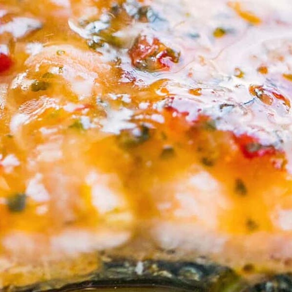 A close up of Sweet Chili Soy Glazed Salmon with sauce on it.