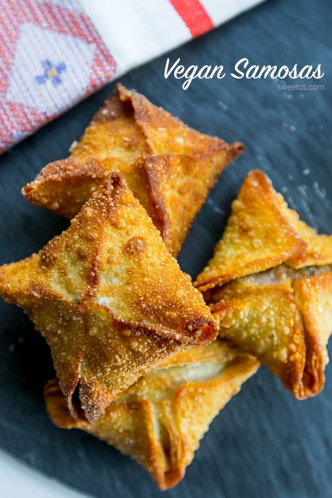 crispy samosas with red chutney on them