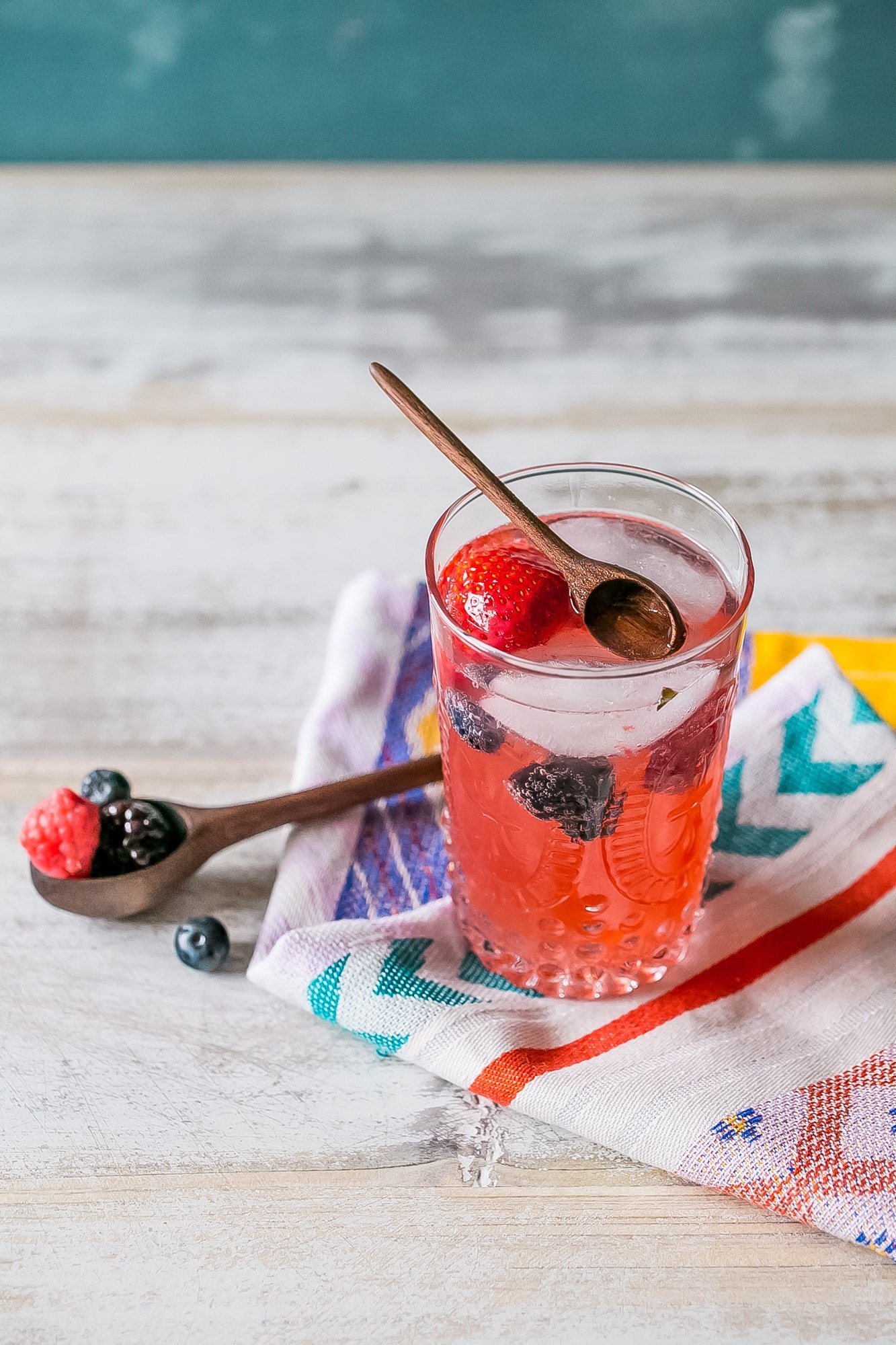 red lemonade with strawberries and blackberries in it