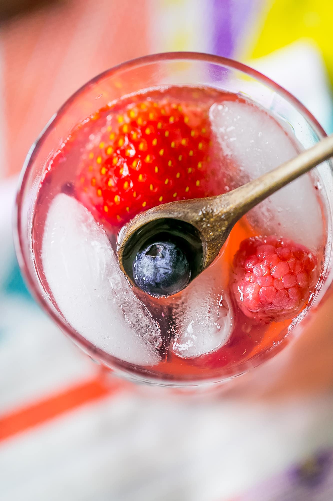 red lemonade with strawberries and blackberries in it