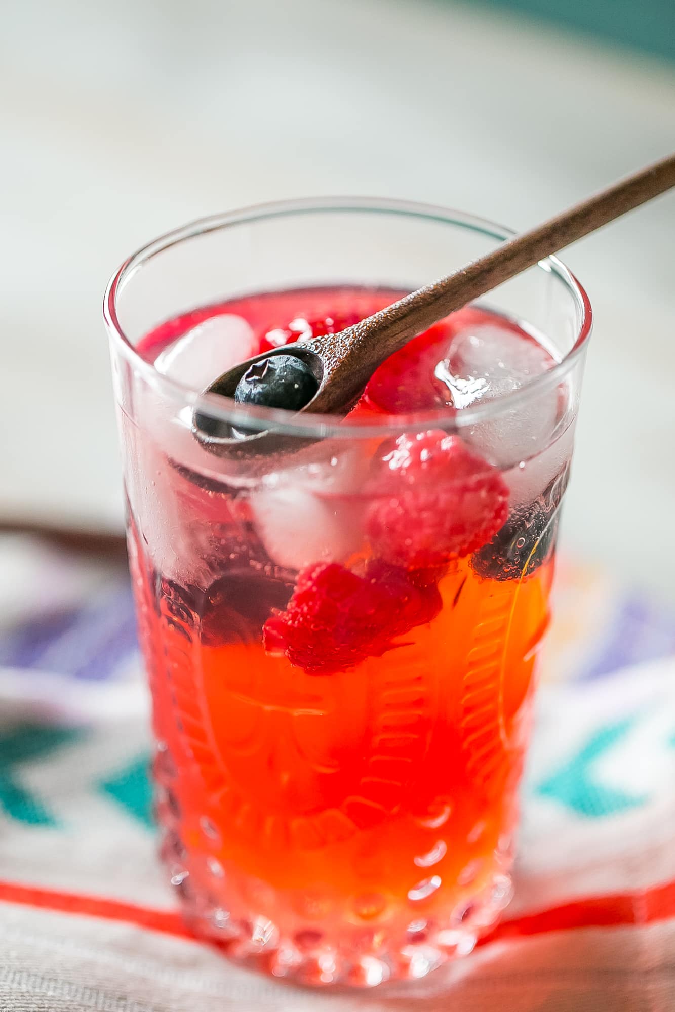 red lemonade with strawberries and blackberries in it