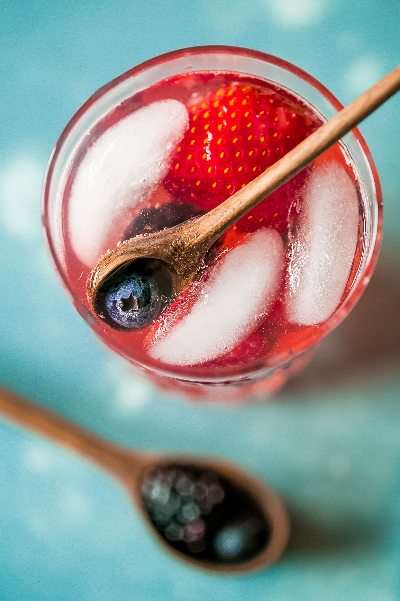 red lemonade with strawberries and blackberries in it