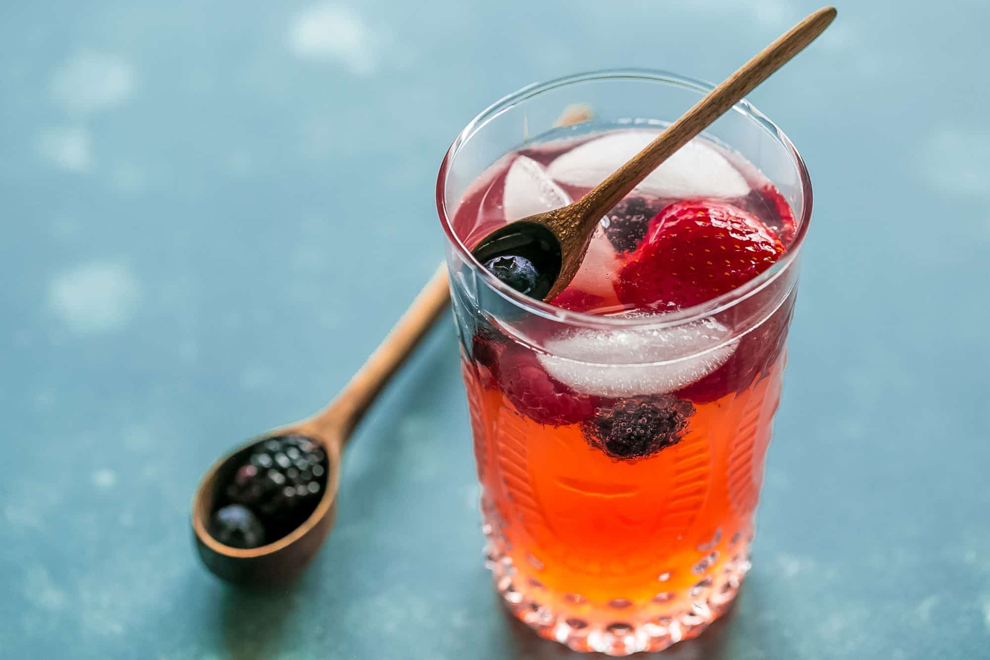 red lemonade with strawberries and blackberries in it