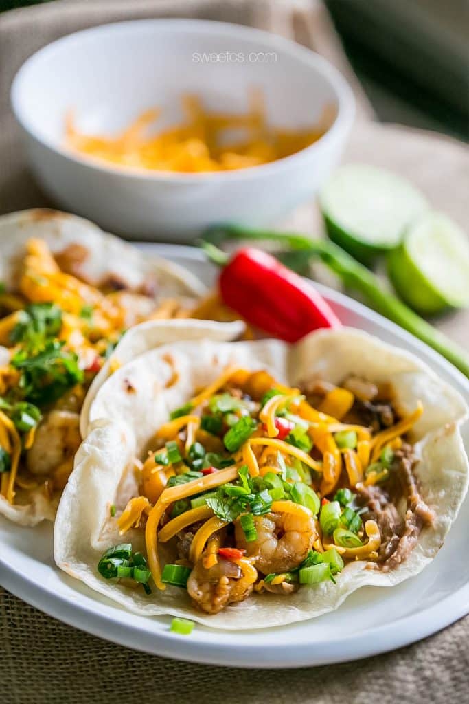 tacos with shrimp, cheese, chives, and refried beans