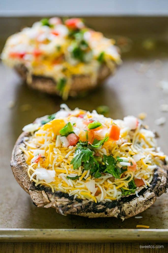 unbaked mushrooms caps with Pico and cheese on them