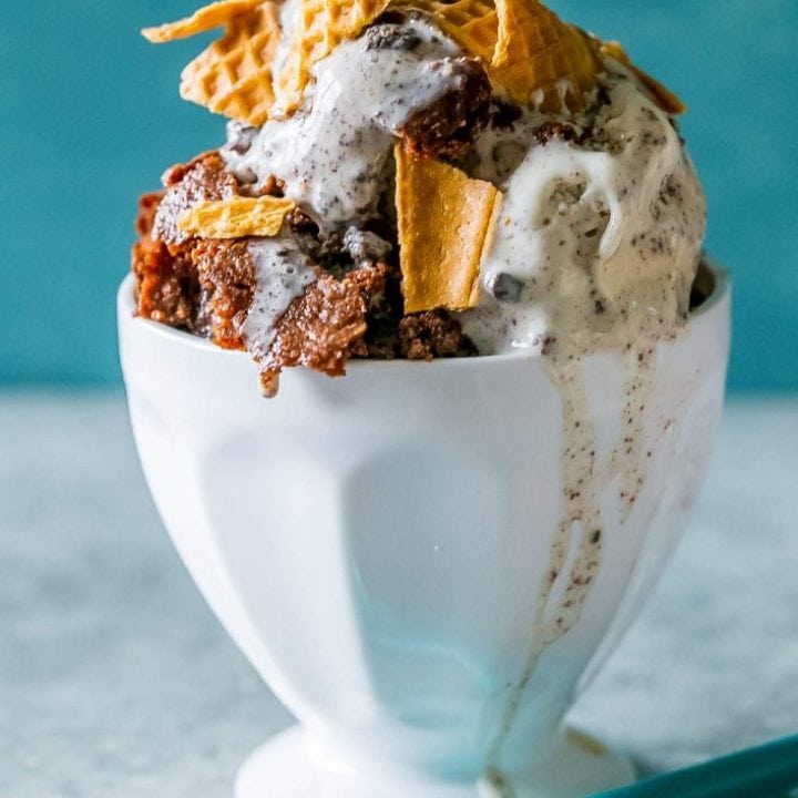 A sundae bowl filled with ice cream and granola.