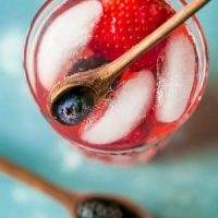 A refreshing sparkling lemonade infused with berries and adorned with ice.