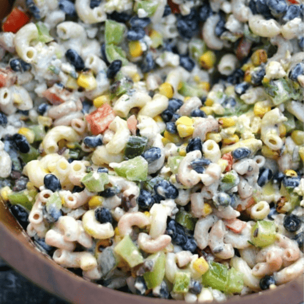 A bowl of cilantro lime black bean pasta salad with corn.