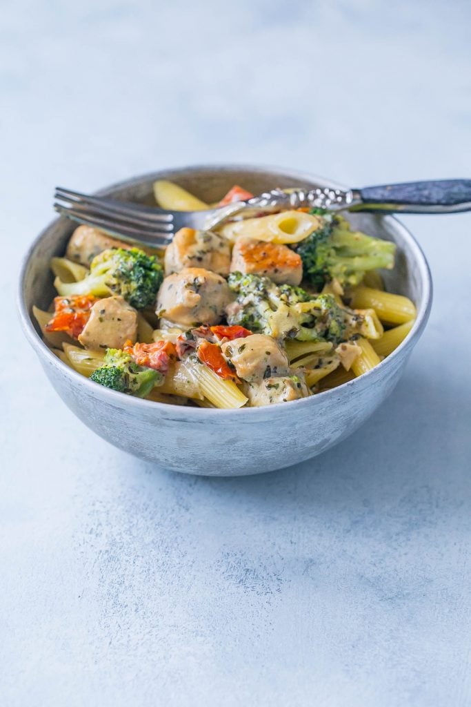 Creamy chicken and broccoli alfredo in  bowl with a fork