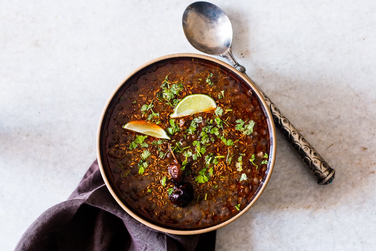 black lentil soup with cilantro and lime