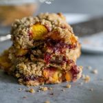 Peach and oatmeal crumble bars stacked on top of each other.