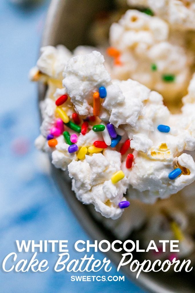 popcorn covered in white chocolate with colorful sprinkles on it