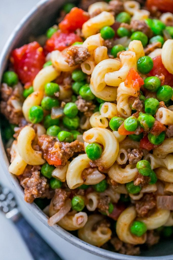 noodles with peas, beef, and tomatoes in it