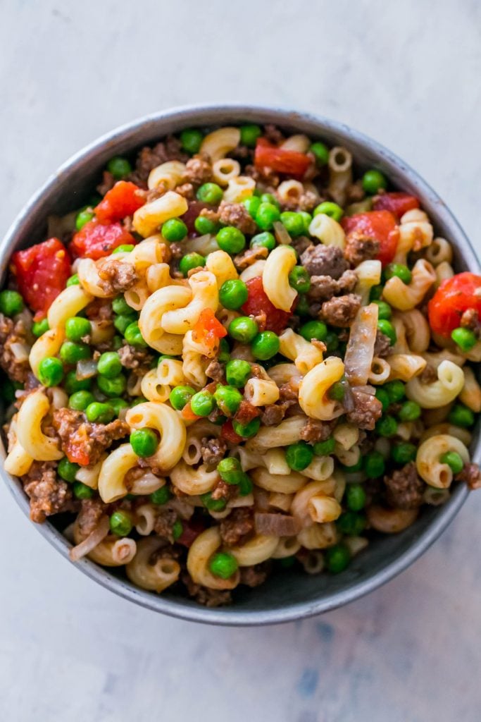 noodles with peas, beef, and tomatoes in it