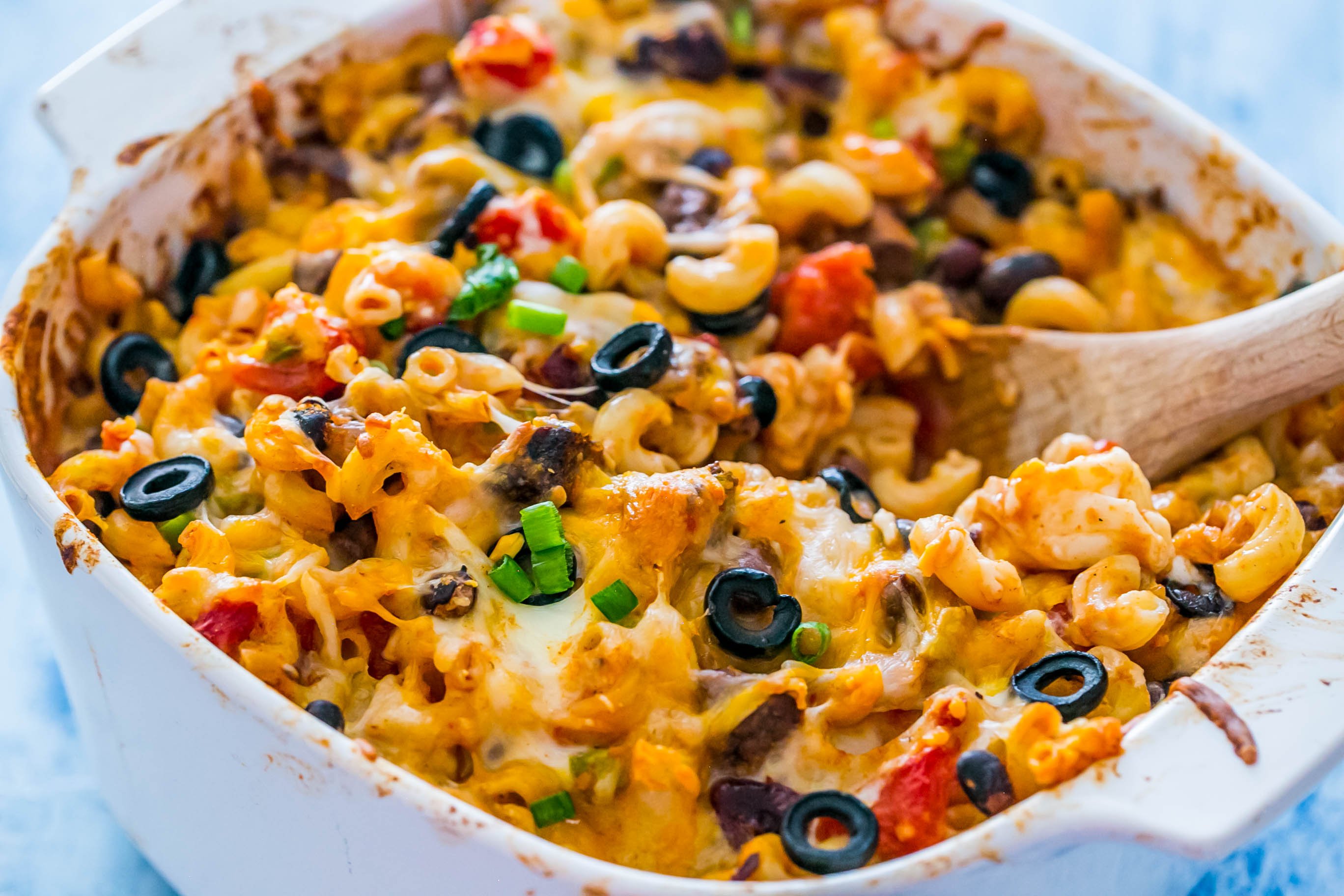 casserole dish with bell peppers, cheese, beans, diced tomatoes, pasta, and steak