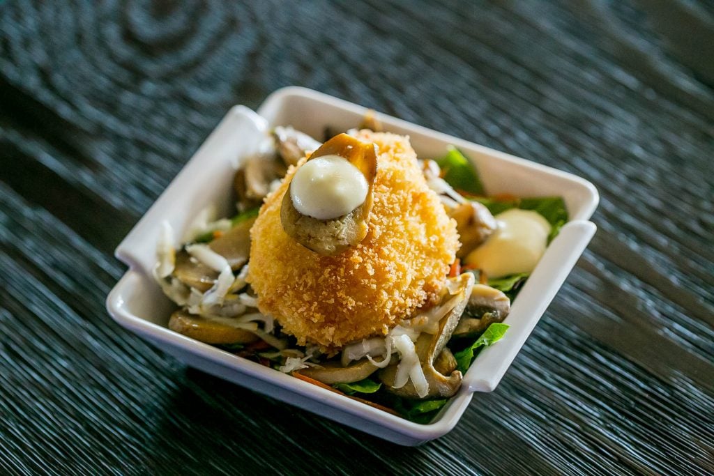 crab cake on salad with mayo on top