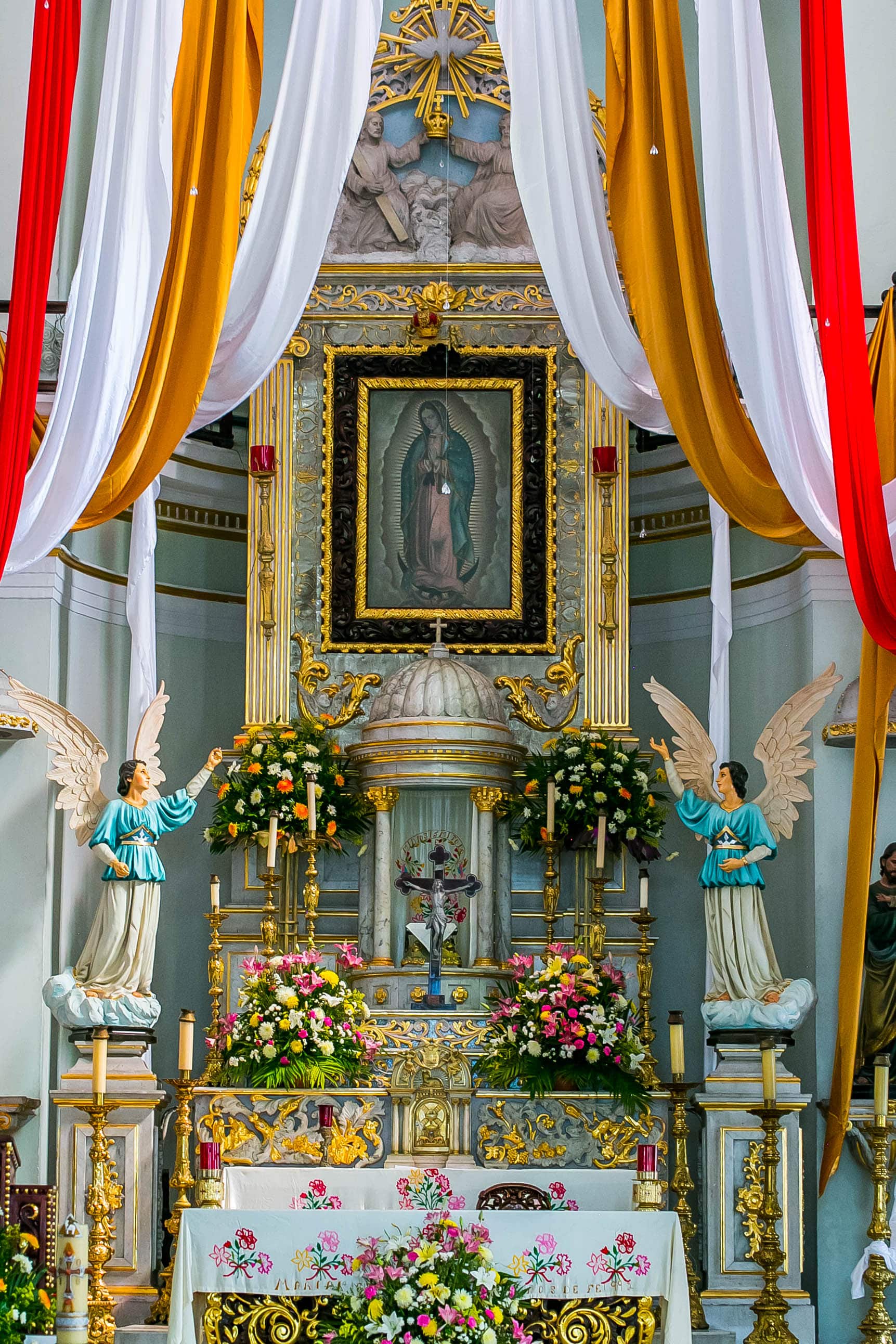 picture of Mary with colorful cloth hanging around it