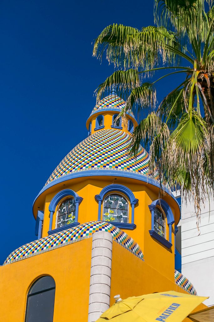 an orange steeple with other tropical colors and palm tree