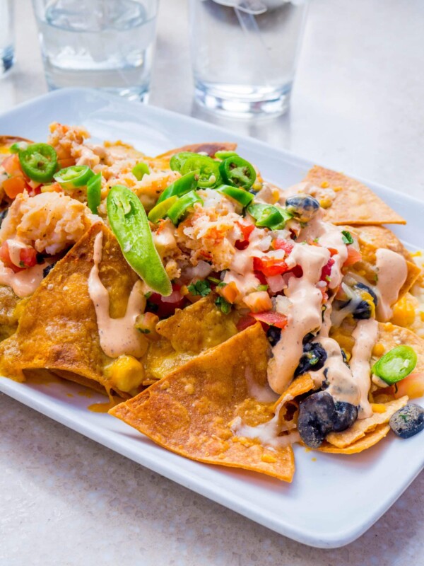 A plate of Puerto Vallarta nachos on a white plate.
