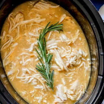 picture of shredded turkey in gravy in a slow cooker