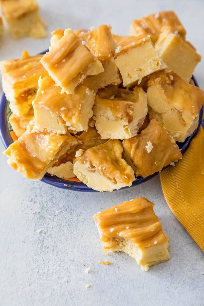 creamy caramel colored fudge stacked on a plate