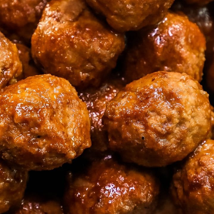 Whiskey BBQ Meatballs in a white bowl on a table.