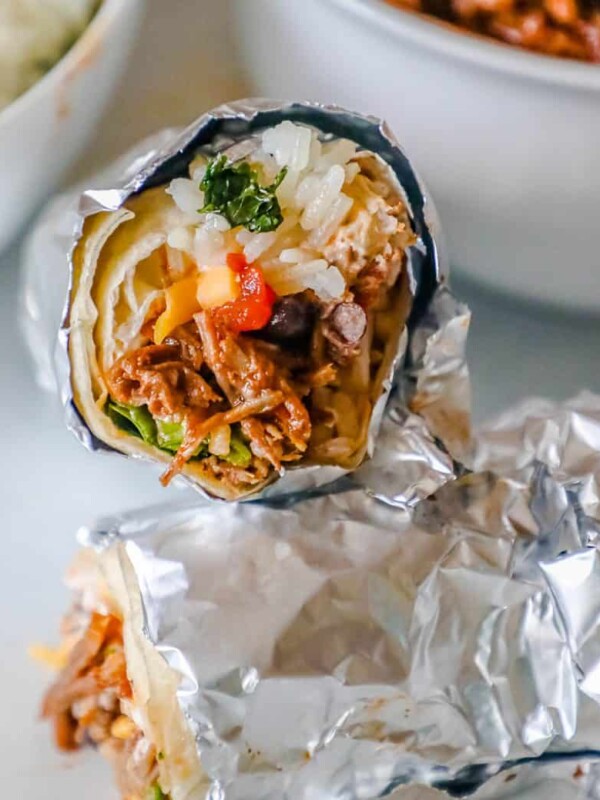 Instant pot Mexican burritos wrapped in foil with chipotle barbacoa, rice, and beans.