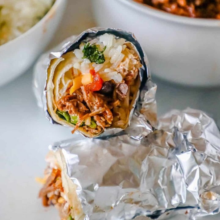 Instant pot Mexican burritos wrapped in foil with chipotle barbacoa, rice, and beans.