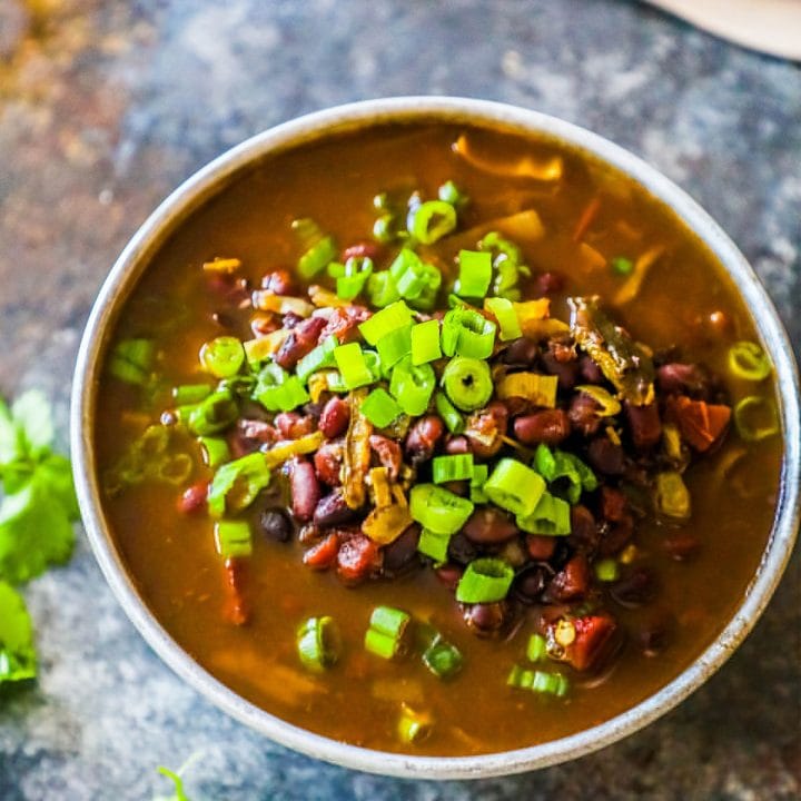 Spicy black bean soup on a table.