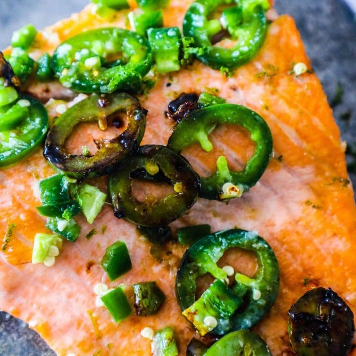 Honey lime jalapeno salmon with peppers on a plate.