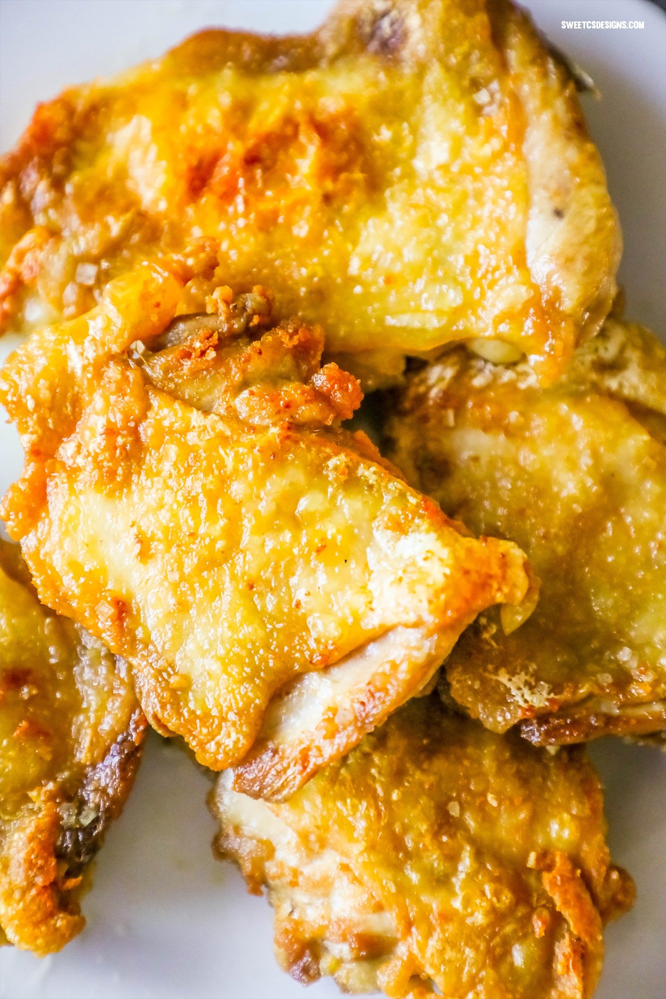 pan fried chicken with crunchy skin on a white plate