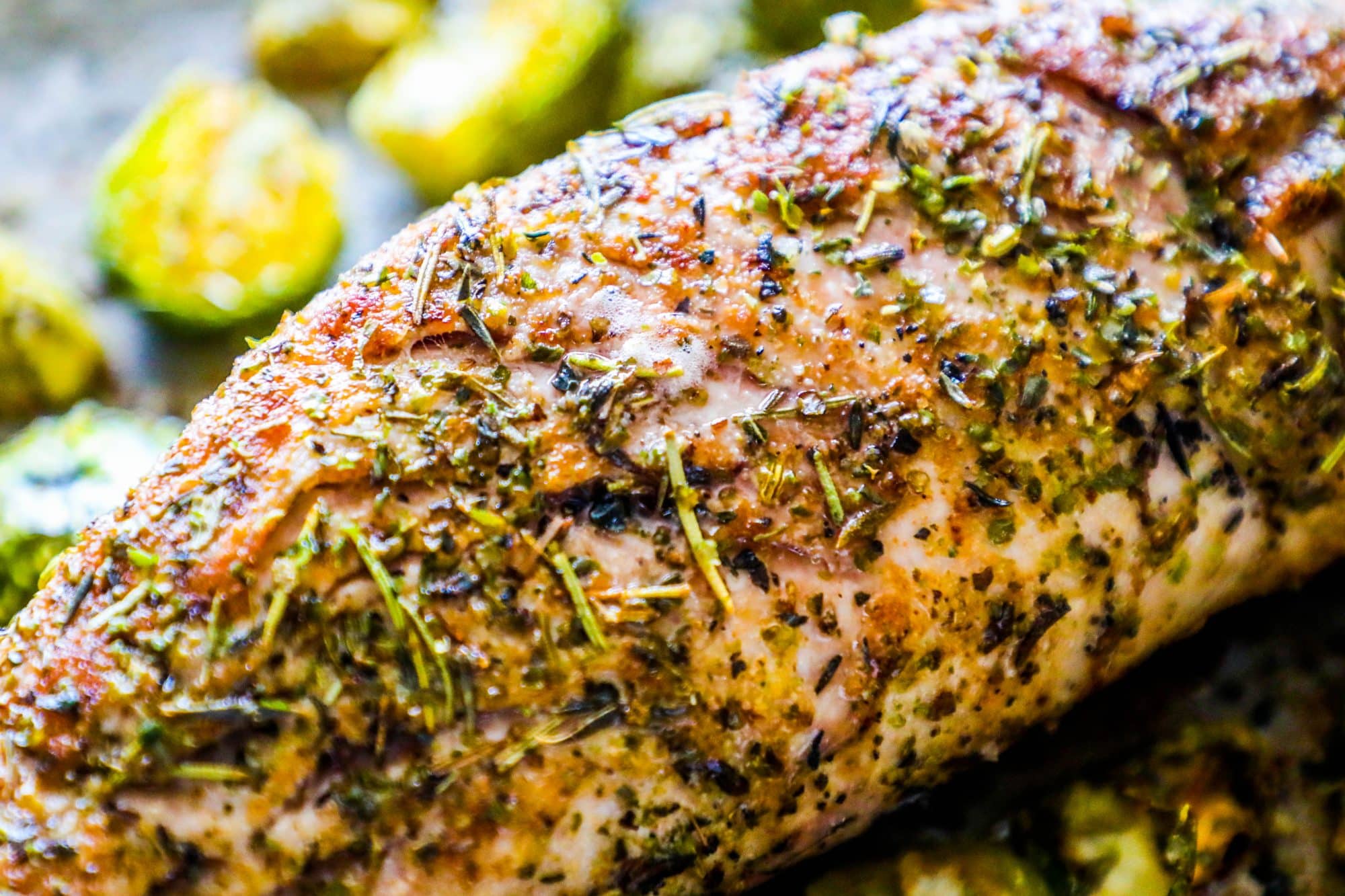 pork covered in italian herbs and veggies on the side