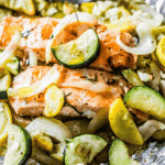 Garlic Herb Salmon and Zucchini grilled in foil with onions.
