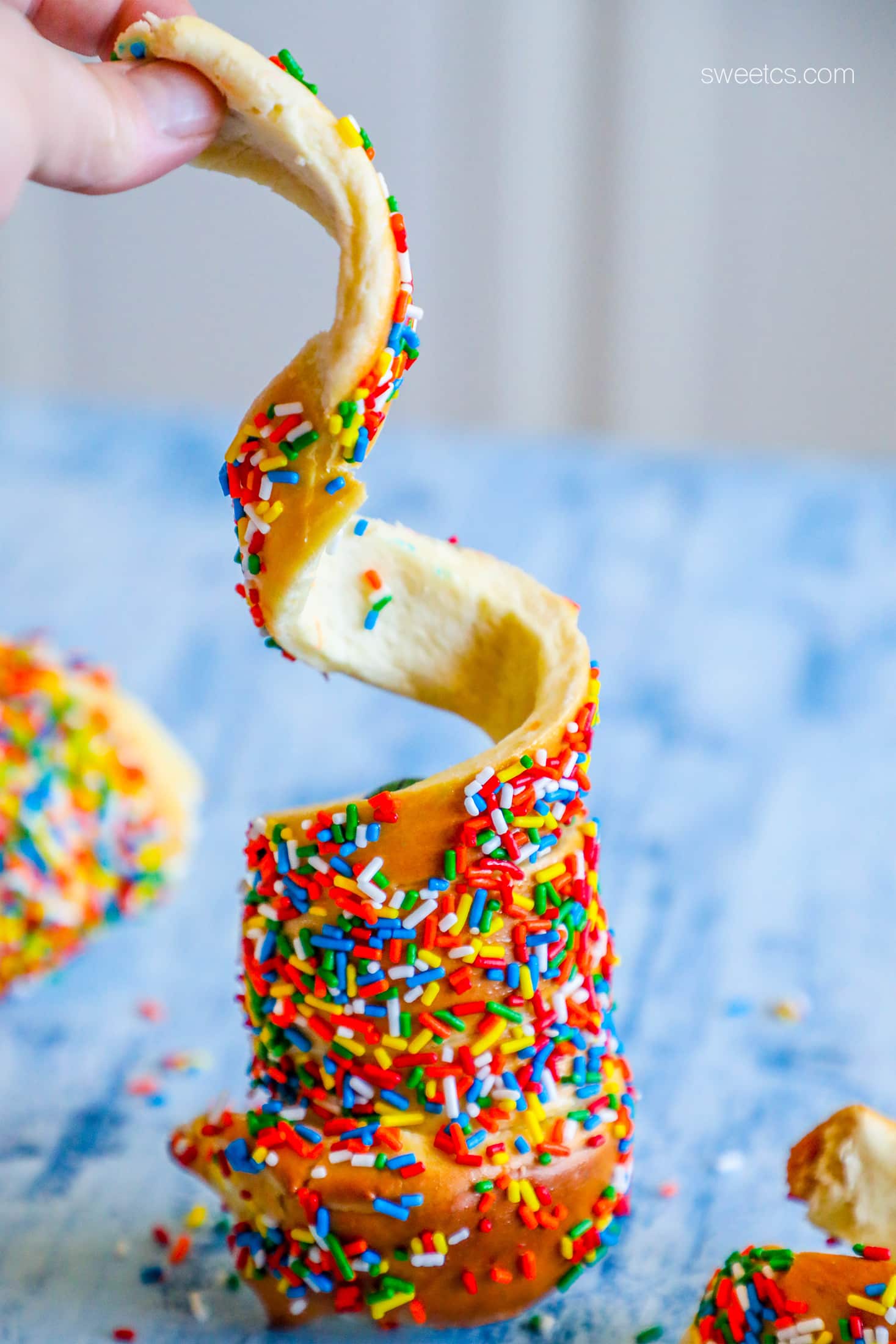 cake in a sphere with sprinkles on it 