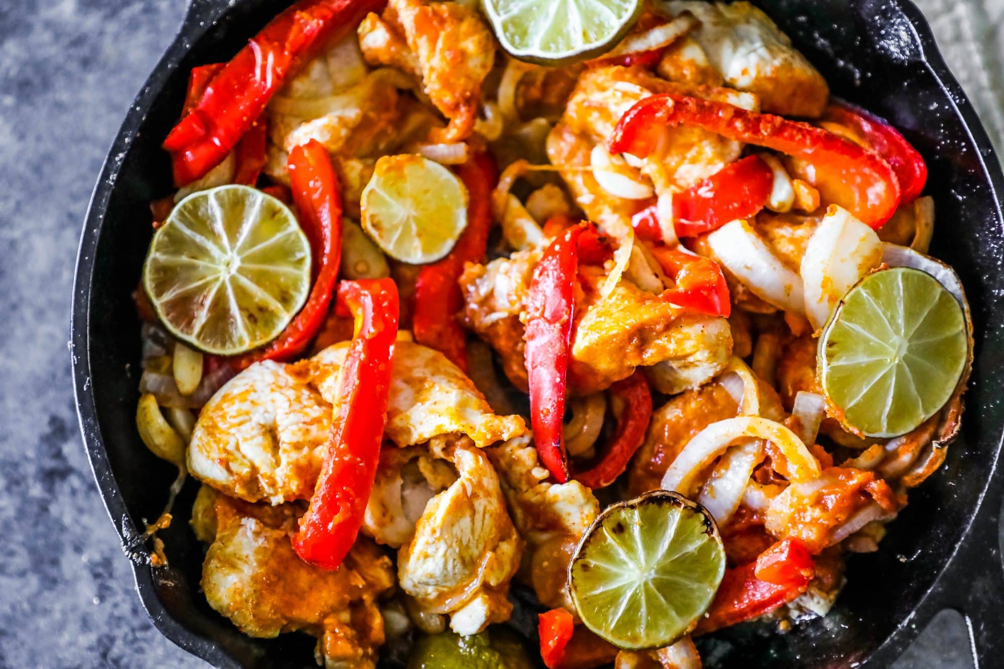 chicken, bell peppers, and lime in a skillet